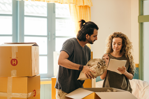 a couple unpacking boxes