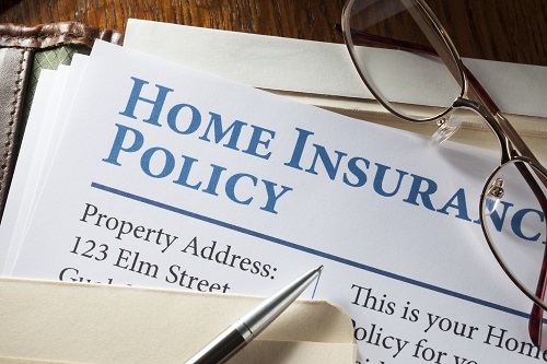 stack of papers with the words homeowners insurance policy visible